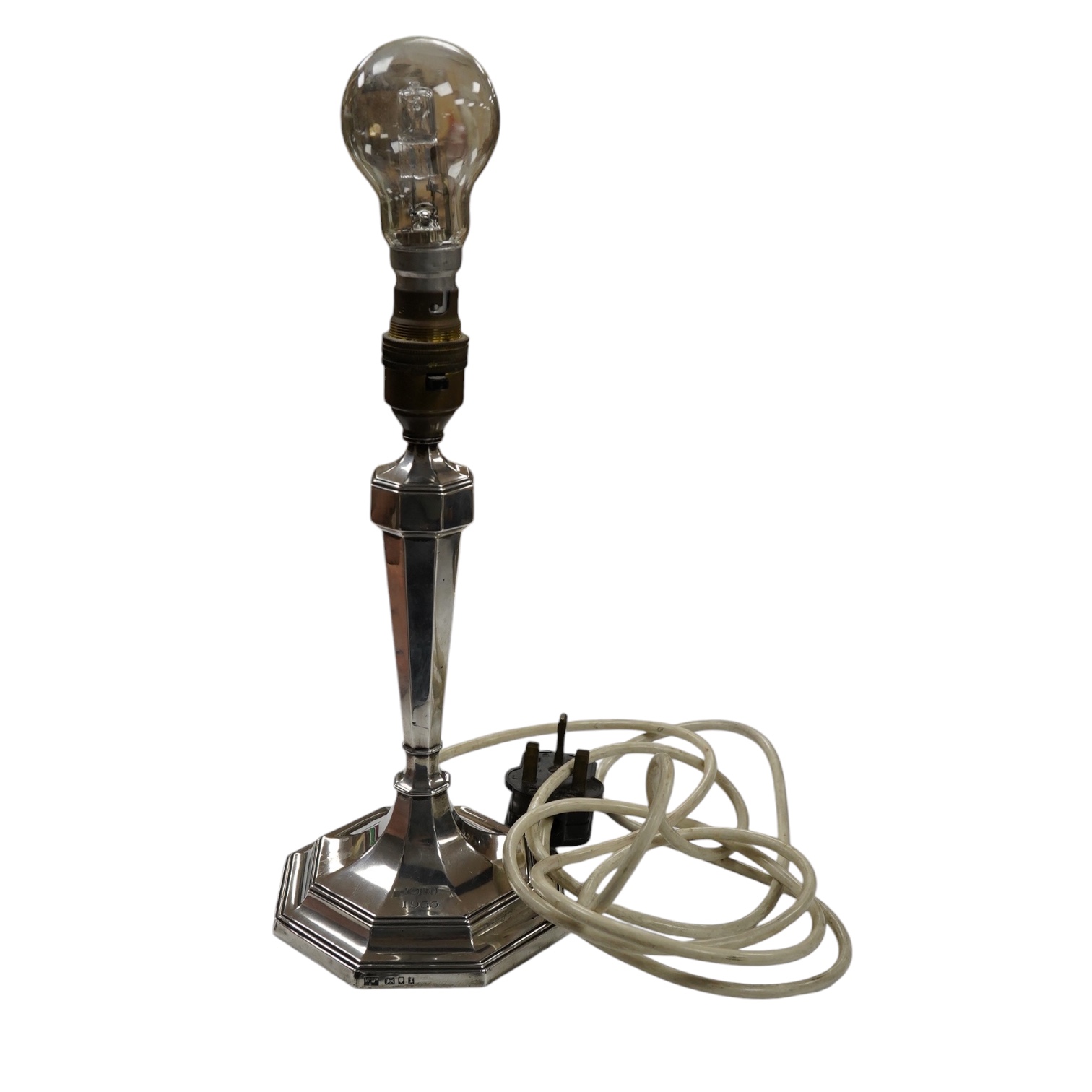 A George V silver octagonal electric lamp base, by Mappin & Webb, London, 1934, with engraved dates, overall 34.2cm. Condition - fair